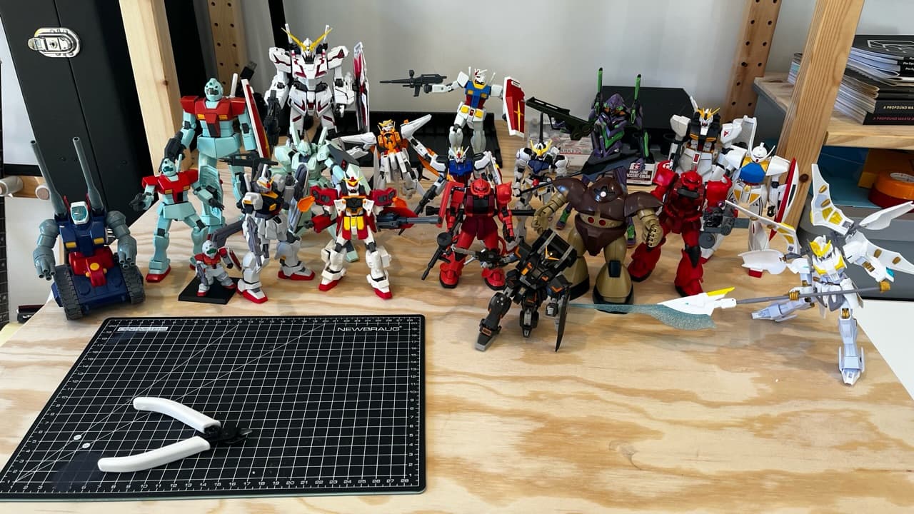 Photo of all my gundam models arranged on my desk.